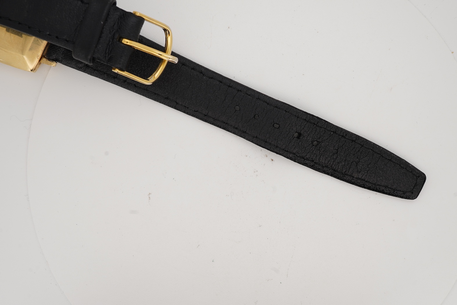 A gentleman's 18ct gold Eterna-Matic 3000 wrist watch, with baton hour marker, centre seconds hand and calendar aperture at 3 o’clock, on an associated black leather strap